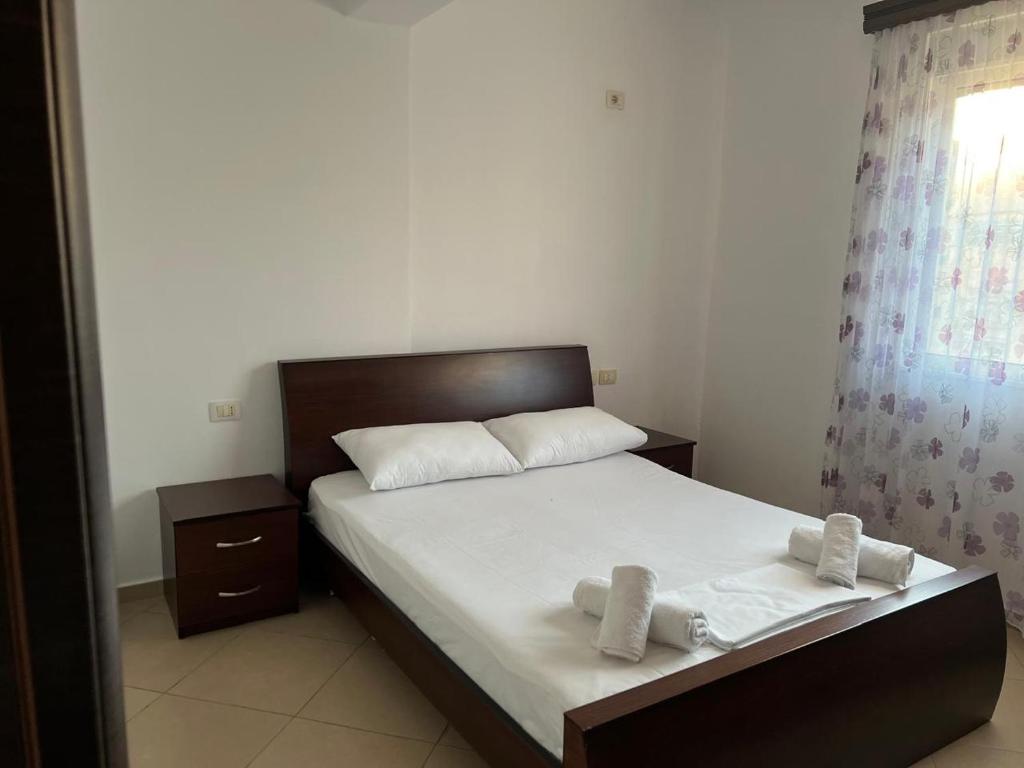 a bedroom with a bed with two towels on it at Saranda Spot Apartment in Sarandë