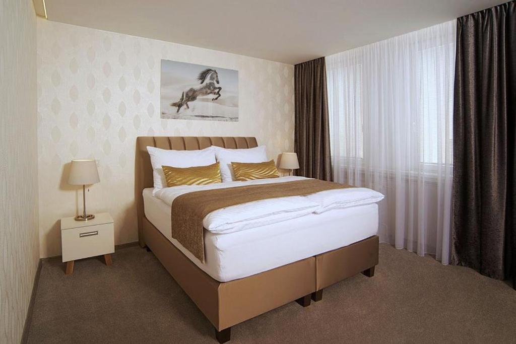 Postel nebo postele na pokoji v ubytování Privilege Apartments