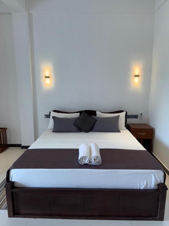 Postel nebo postele na pokoji v ubytování Devon Surf Inn Arugambay