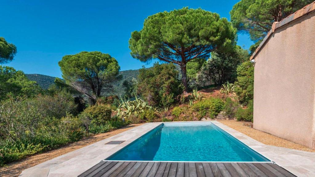 - une piscine à côté d'une maison arborée dans l'établissement Villa églantine- Piscine- calme, au Lavandou