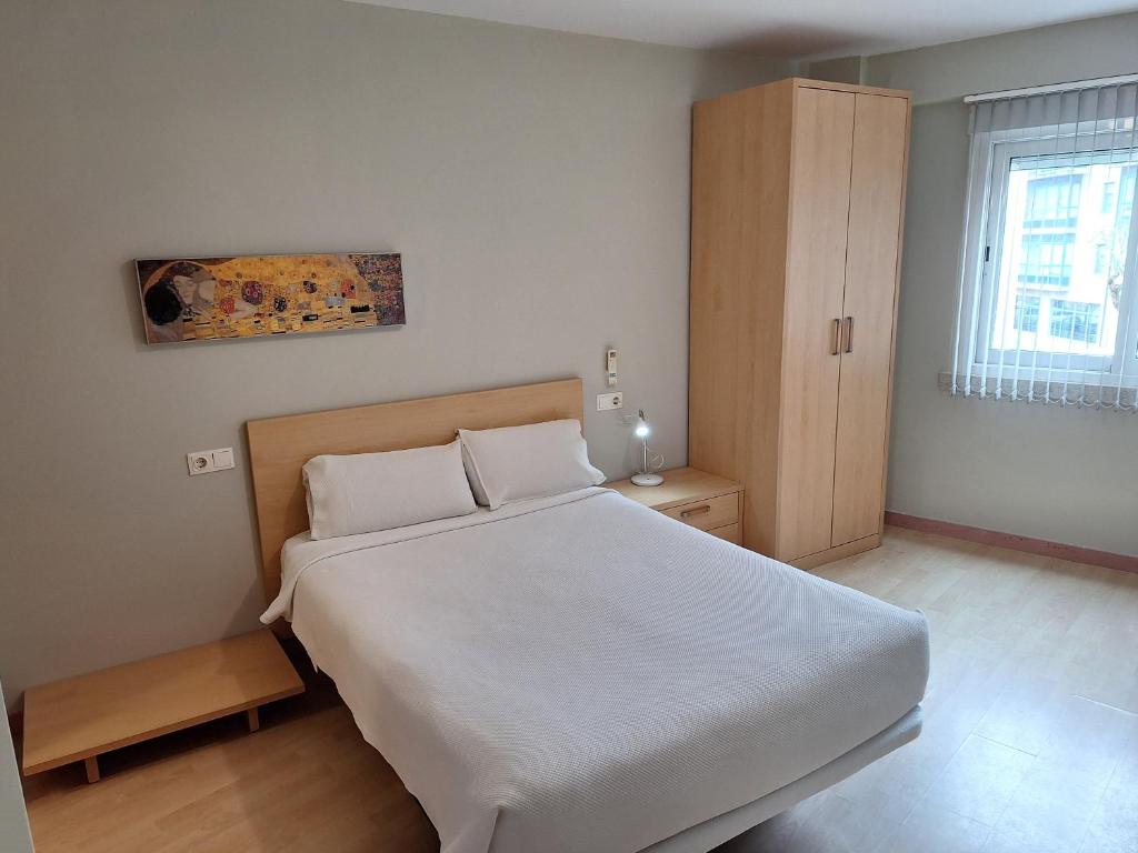 Een bed of bedden in een kamer bij PR Blanco