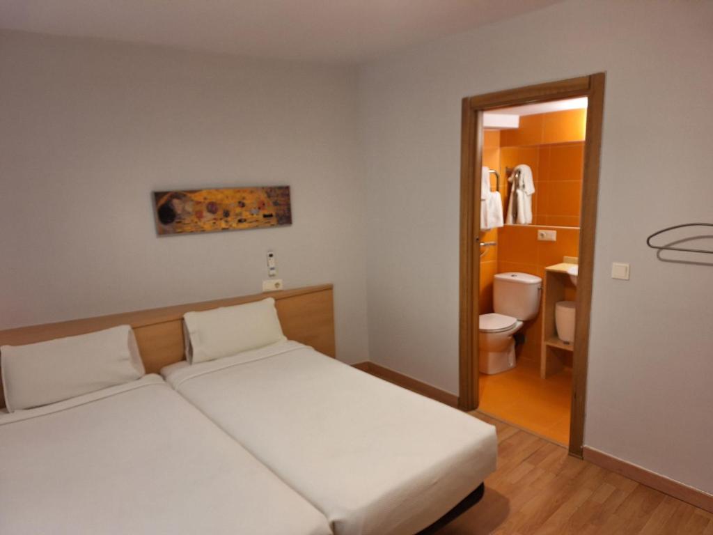 Een bed of bedden in een kamer bij PR Blanco