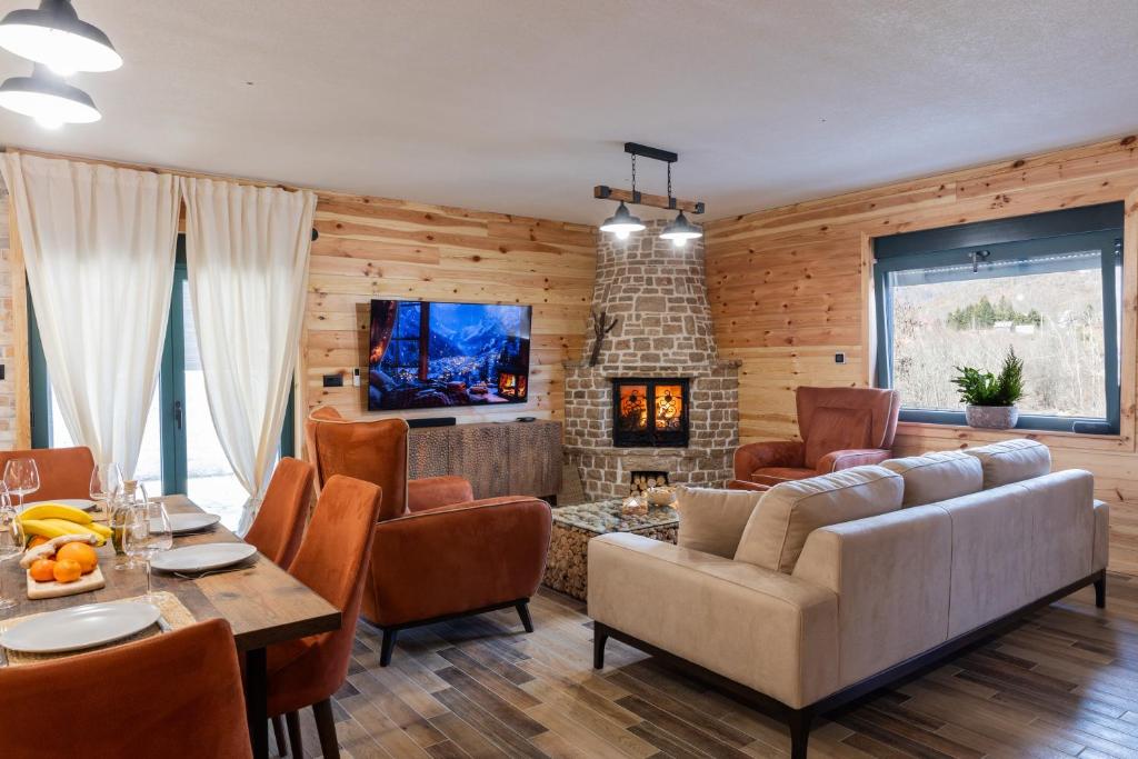 a living room with a couch and a table at Villa Vucje near Kolasin in Kolašin