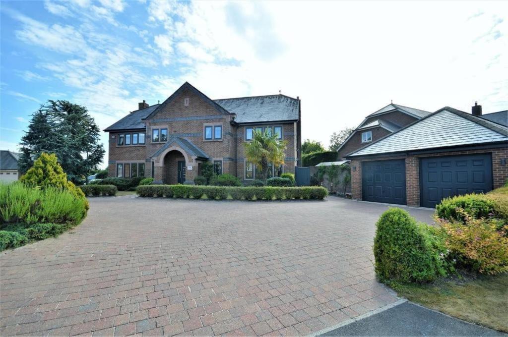 a large brick house with a large driveway at Lavish4Bed Mansion in Warrington in Warrington