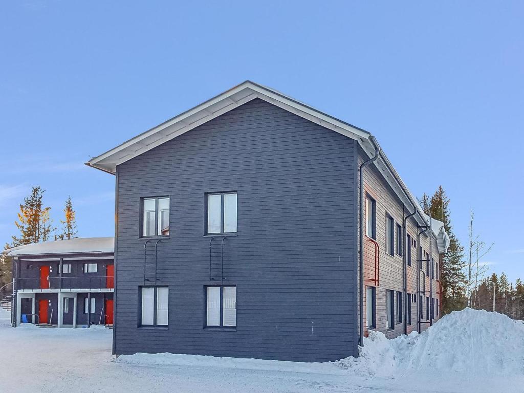 a black building with snow in front of it at Holiday Home Levistar vi as- 6106 by Interhome in Levi