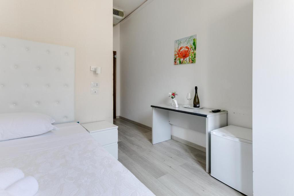 Postel nebo postele na pokoji v ubytování Hotel La Perla Rimini