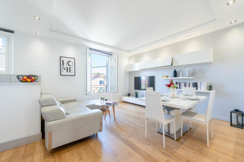 une cuisine et une salle à manger avec une table et des chaises dans l'établissement Air-Conditioned 2-Br Apartment with Garage Near the Beach, à Cannes