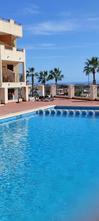 a large blue swimming pool in front of a building at Casa Altaona in Sucina