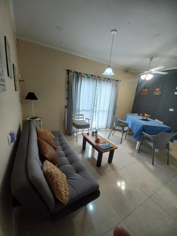 a living room with a couch and a table at Deptos de Lili 2 in Termas de Río Hondo