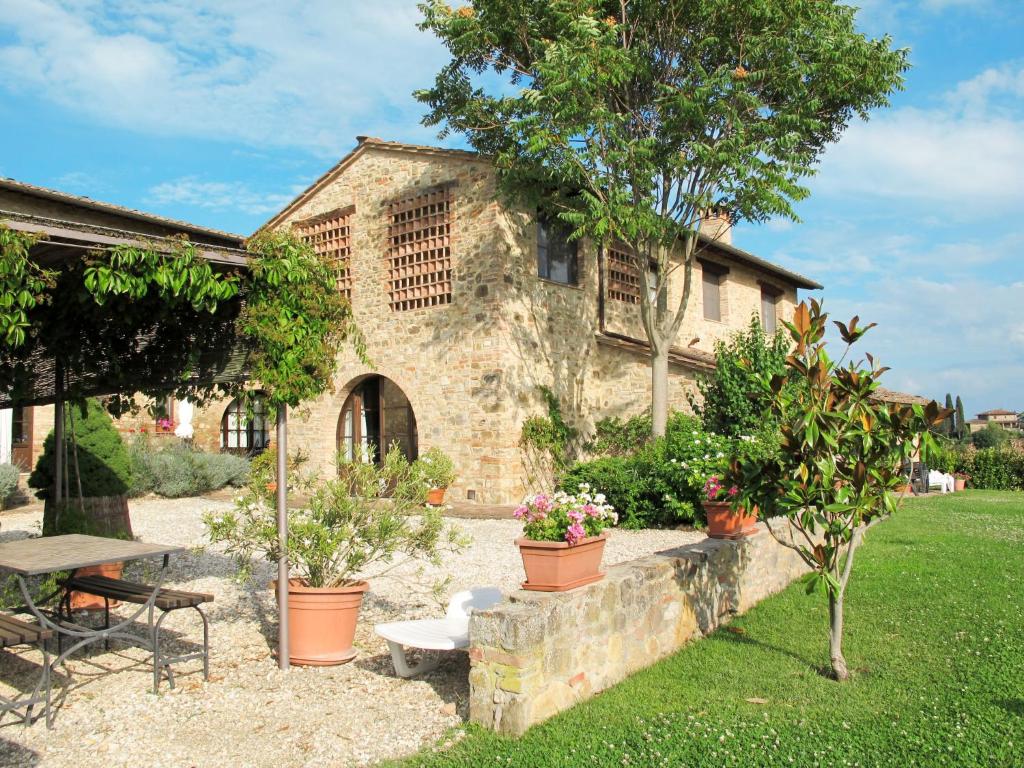 a stone house with potted plants in a yard at Holiday Home Linearis K by Interhome in SantʼAppiano