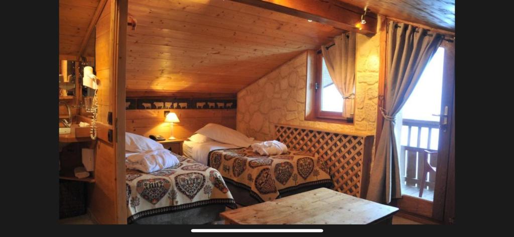 Postel nebo postele na pokoji v ubytování Hôtel Chalet Alpage