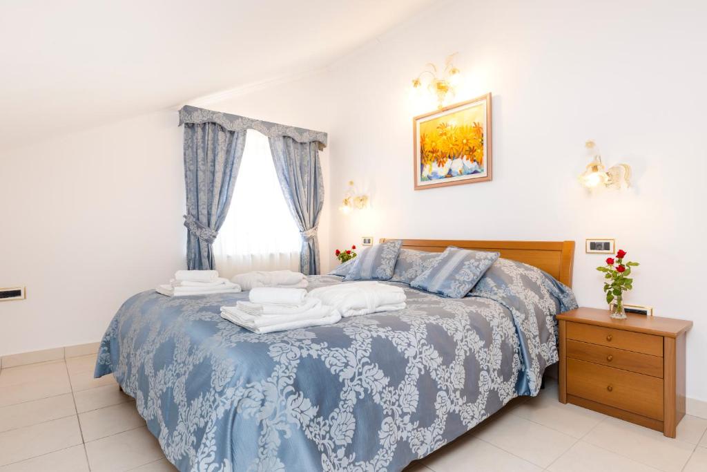 Postel nebo postele na pokoji v ubytování Villa Cassia