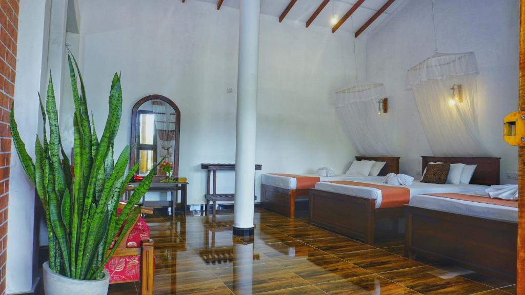 Postel nebo postele na pokoji v ubytování Sigiri Dilu Villa