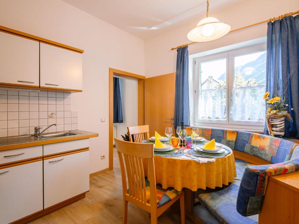 a kitchen and living room with a table and a couch at Apartment Rosengartenhof-5 by Interhome in Andrian