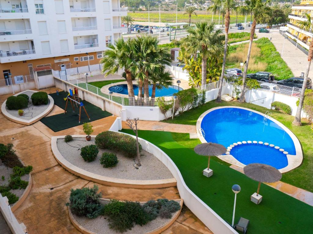an overhead view of a resort with two pools and palm trees at Apartment Cala Mora by Interhome in Moraira