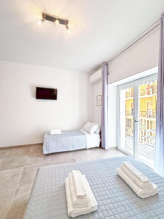 Postel nebo postele na pokoji v ubytování NEMO BnB ALGHERO CENTRE