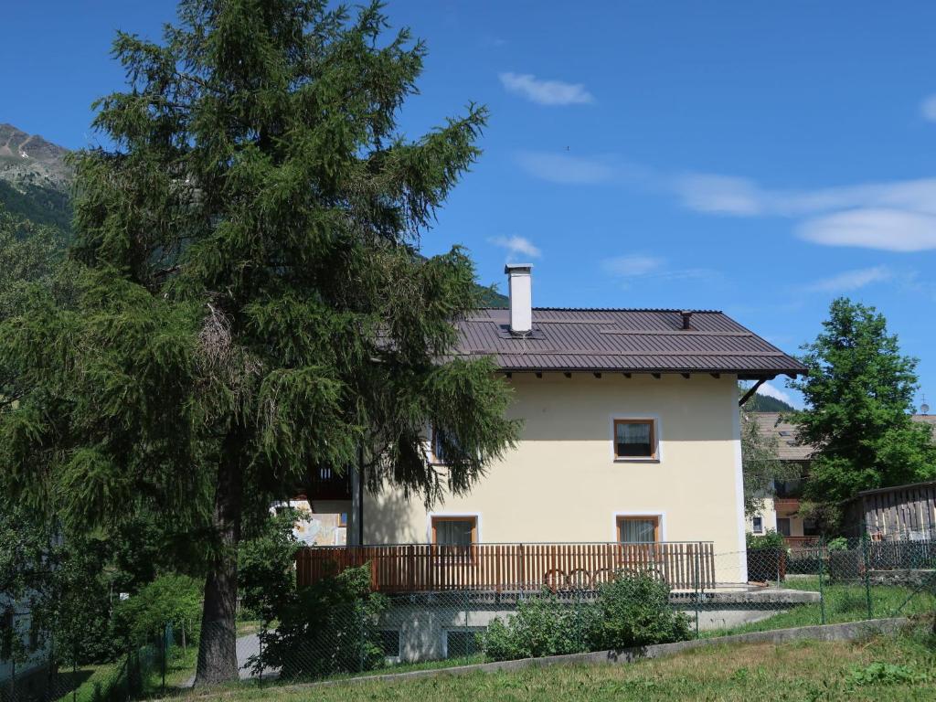 a white house with a balcony and a tree at Apartment Nebenhaus Schönblick - SVH112 by Interhome in San Valentino alla Muta