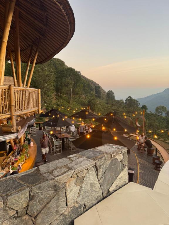 a view of a building with people sitting at tables at Sundaras Infinity Jungle Resort & Spa in Dambulla