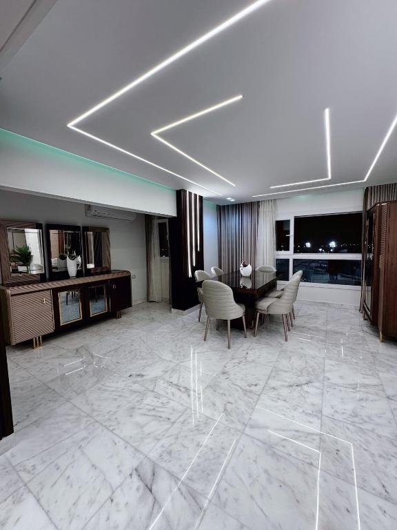 a living room with a table and chairs at Luxury three bedroom duplexSheraton Airport in Cairo