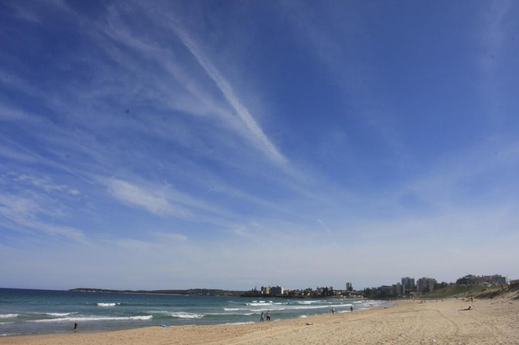 a beach with a blue sky and the ocean at U1 - Quaint 1 Bedroom Unit, Wanda Beach in Cronulla