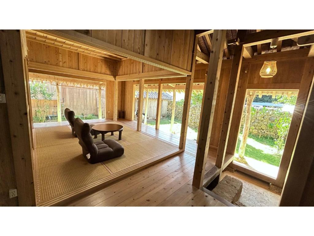 a living room with a chair and a table at Akagawara no Kominka Pukarasa - Vacation STAY 42241v in Imadomari