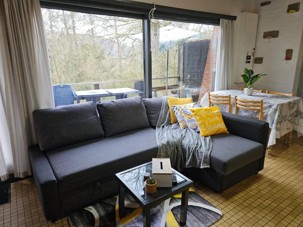 a living room with a couch and a table at Wali's Nature Bliss Dinant Givet in Waulsort