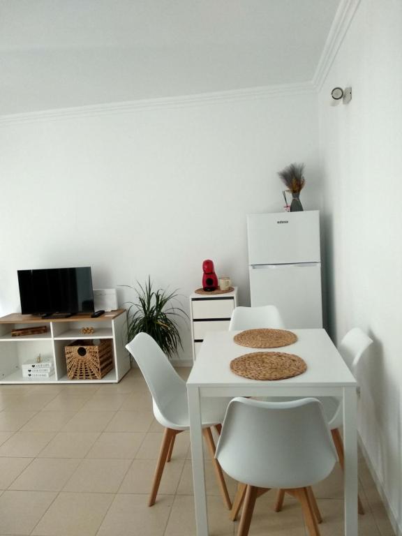 a white dining room with a white table and chairs at Zen Apartment Tenerife in San Miguel de Abona