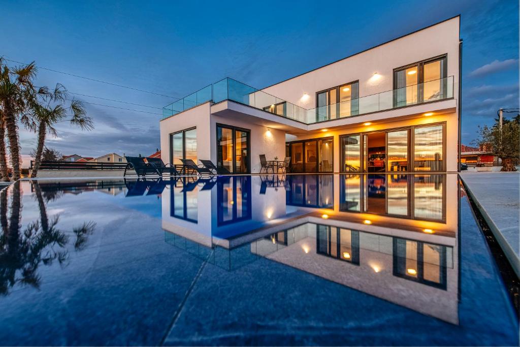 a house with a pool in front of it at Villa Stressless in Smoković