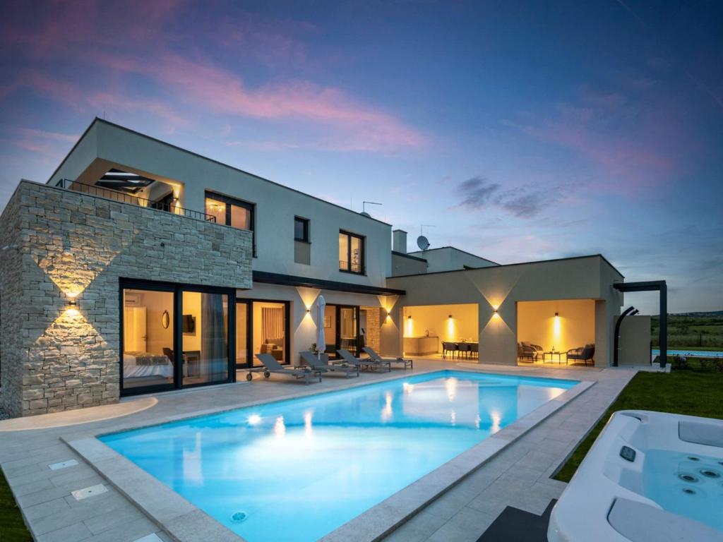 a villa with a swimming pool at night at Villa Stella by Interhome in Brtonigla