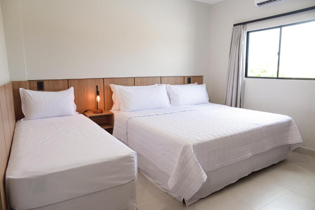 Ένα ή περισσότερα κρεβάτια σε δωμάτιο στο Hotel Caminhos da Oiticica