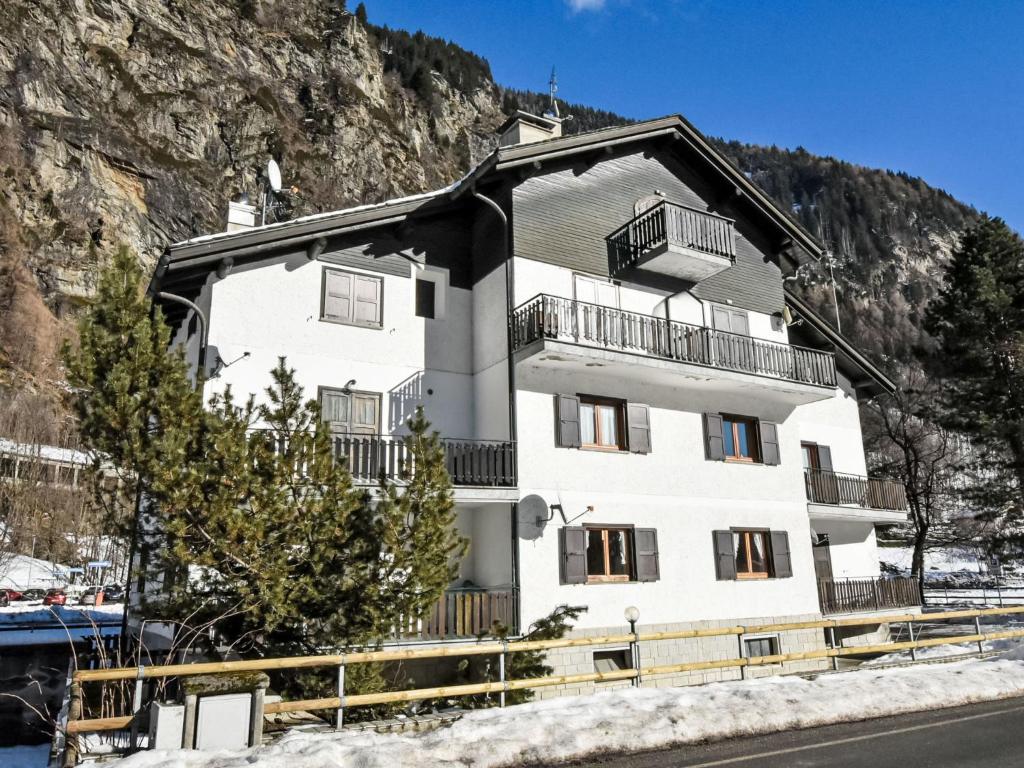 a white building with balconies on the side of a mountain at Apartment Leonardi Terrace by Interhome in Campodolcino