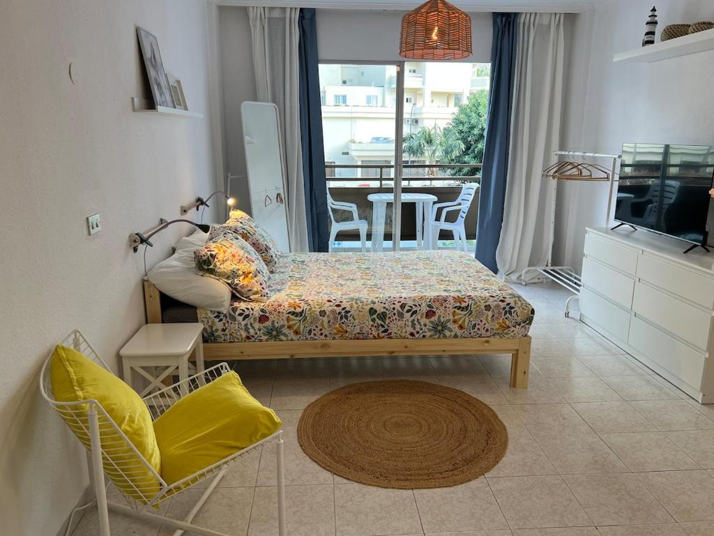 a living room with a bed and a television at 222 Puerto de la Cruz in Puerto de la Cruz