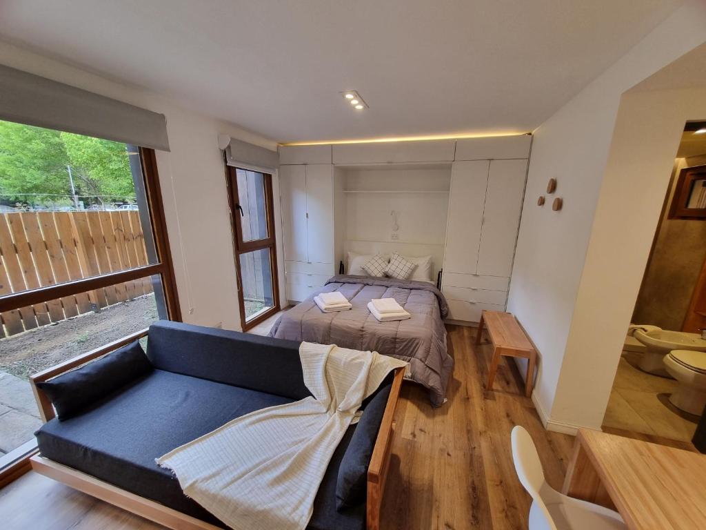 Ένα ή περισσότερα κρεβάτια σε δωμάτιο στο Alamos del Rio - Andarlibre