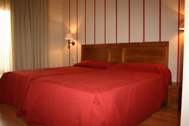 Postel nebo postele na pokoji v ubytování Hotel Cariñena