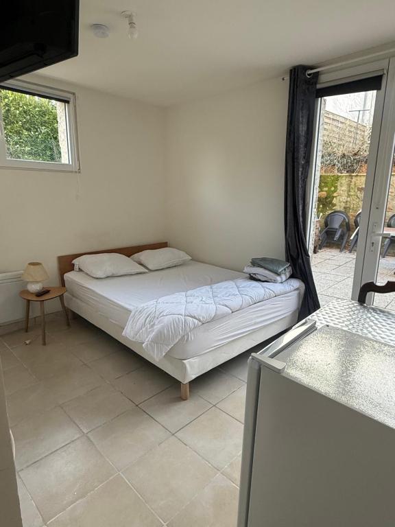 a bedroom with a bed in a room with a window at Chez Nenette in Nogent-sur-Seine