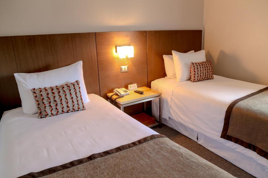 Postel nebo postele na pokoji v ubytování Hotel Martín Gusinde