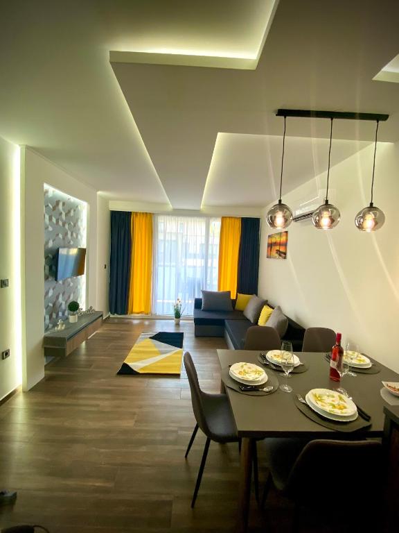 a living room with a table and a couch at Pegazus Apartman in Keszthely