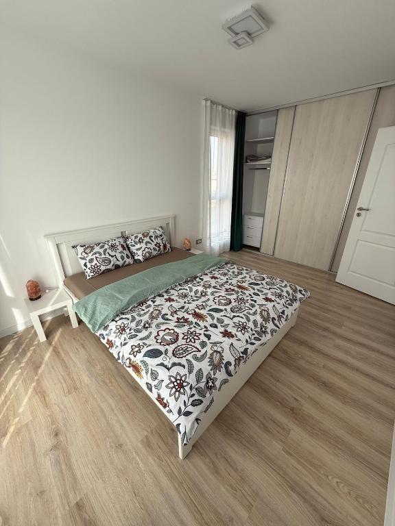 a bedroom with a bed with a black and white comforter at Victor's in Cluj-Napoca