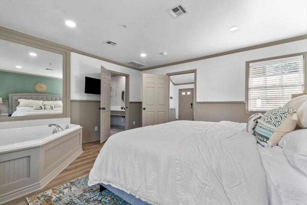 a bedroom with a large bed and a bath tub at The Harmony at Jarrett Farm Resort in Ramona