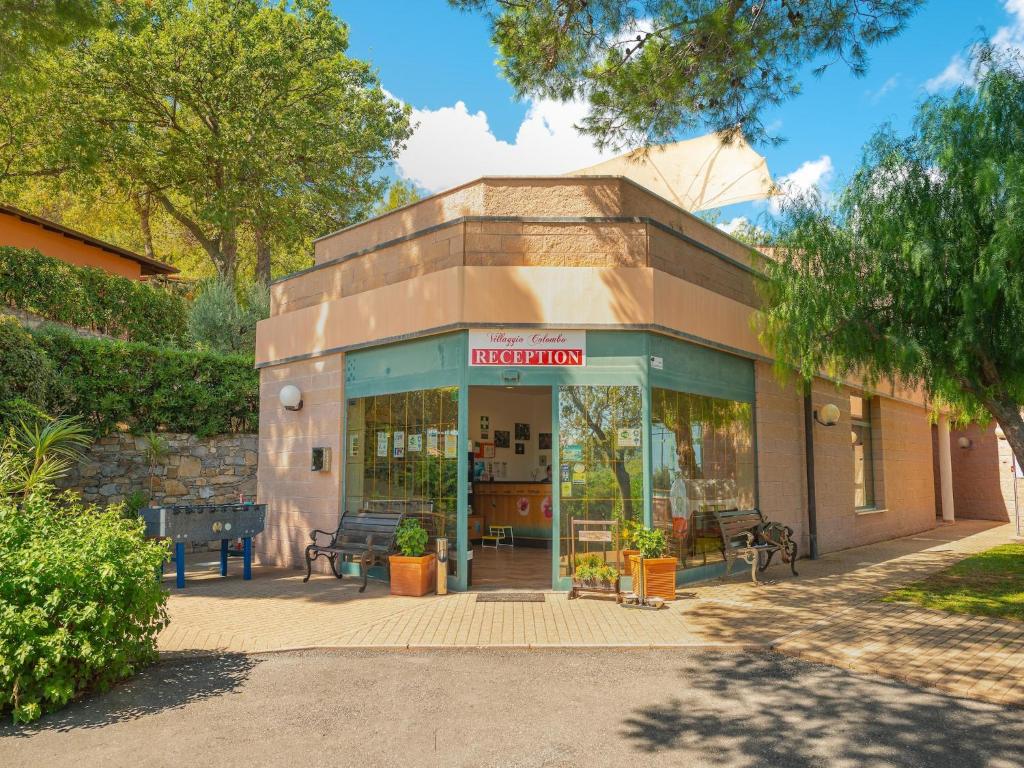 a store front of a building with benches outside at Appartements mit Veranda, Andora in Marina di Andora