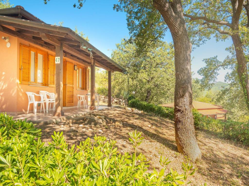 a house with a porch with chairs and a tree at Appartements mit Veranda, Andora in Marina di Andora