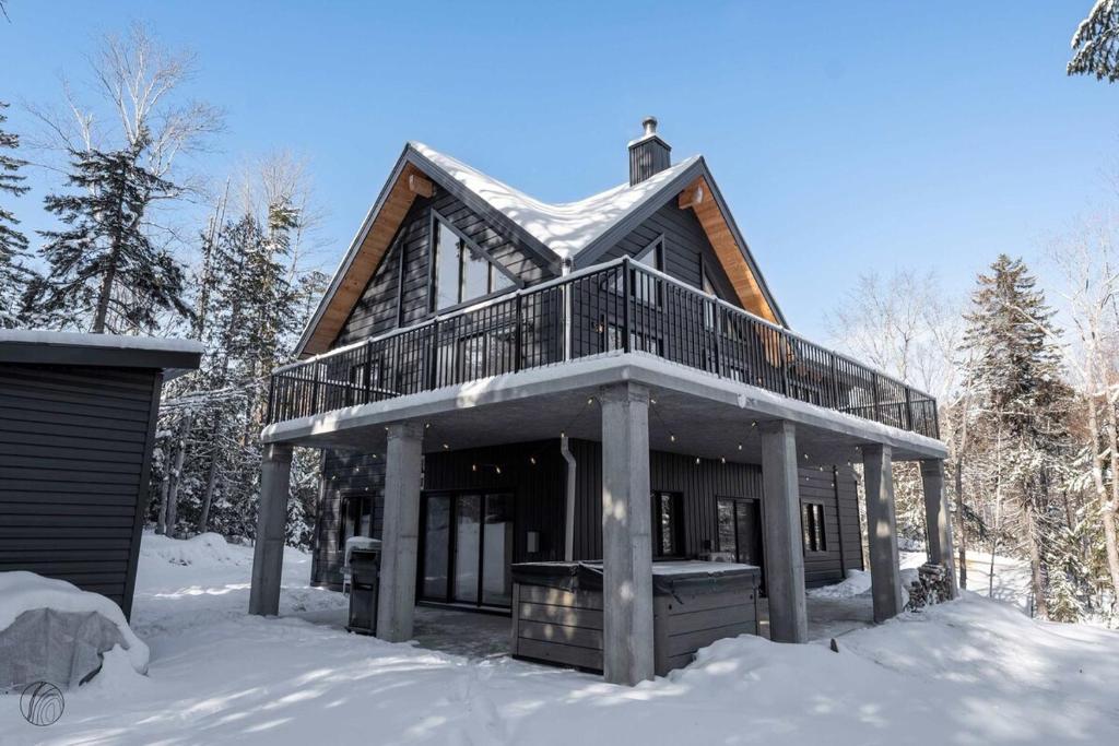 a log cabin in the snow with snow at ÔShack - spa - billiard in Saint Come