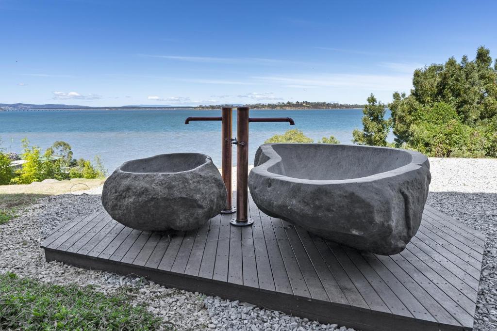 a bath tub sitting on a table next to the water at Stylish Home with Outdoor Area & Spectacular Views in Penna
