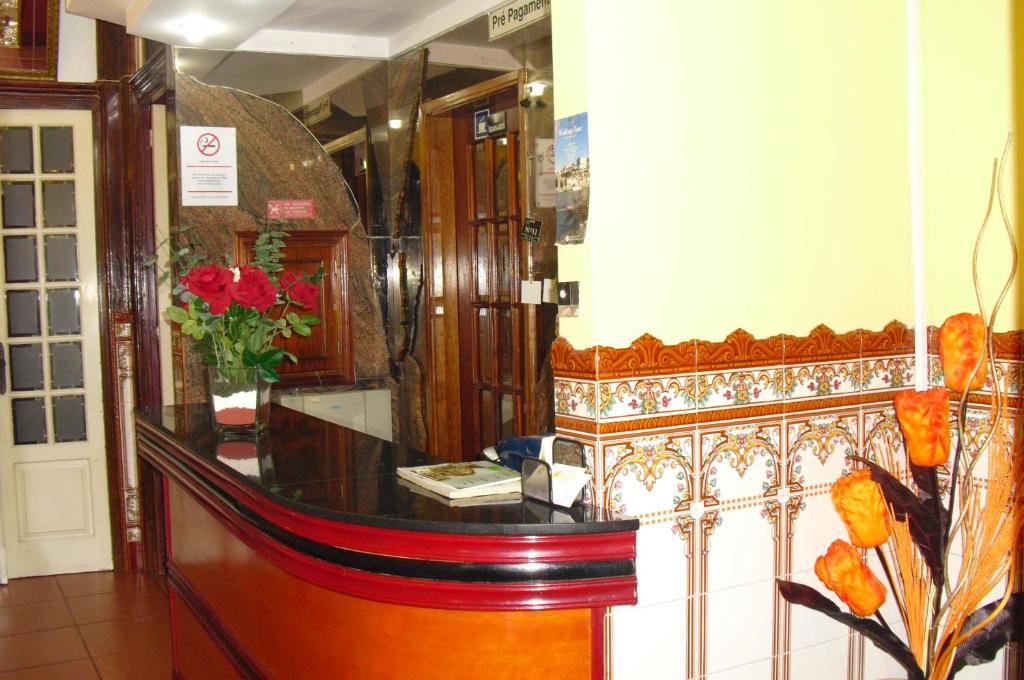 a dressing room with a counter with flowers on it at Residencial Sol da Nave in Porto