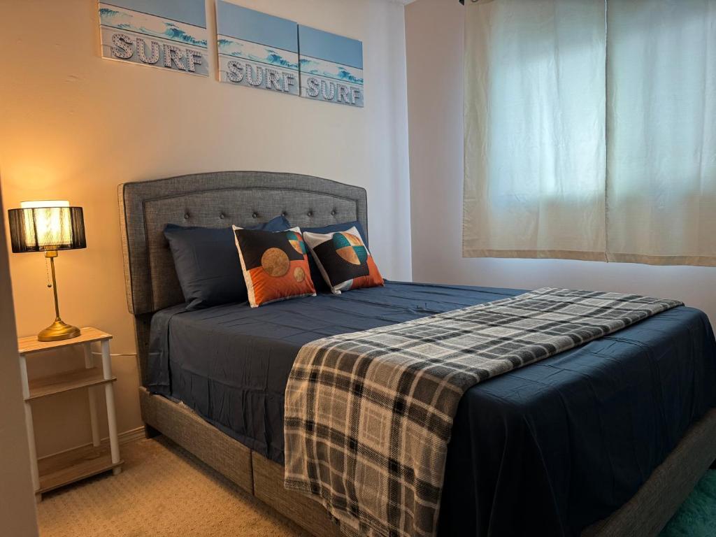 Un dormitorio con una cama con un edredón azul. en Peace Stay, en Edmonton
