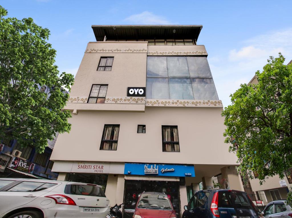 a building with a qox sign on the side of it at Super Hotel O Smriti Star in Bhopal