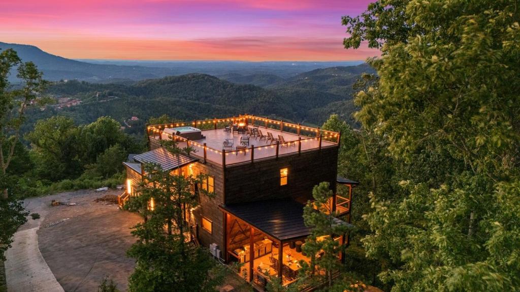 an aerial view of a house in the mountains at Honeybear Hideaways - #1 Luxury Haven Cabin with Breathtaking Mountain Views, Indoor Pool, Bowling Alley, and Golf in Pigeon Forge
