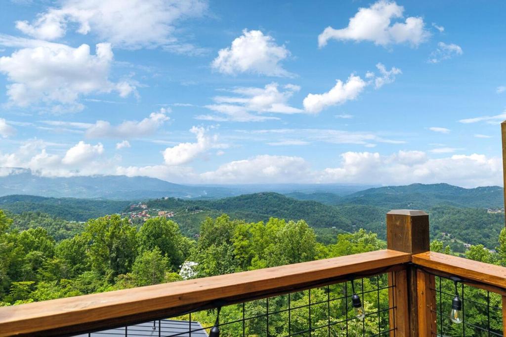 a view of the mountains from the balcony of a house at Honeybear Hideaways - #1 Luxury Haven Cabin with Breathtaking Mountain Views, Indoor Pool, Bowling Alley, and Golf in Pigeon Forge
