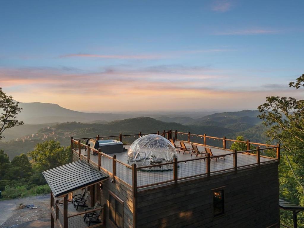 a house with a glass dome on top of a roof at Honeybear Hideaways - #1 Luxury Haven Cabin with Breathtaking Mountain Views, Indoor Pool, Bowling Alley, and Golf in Pigeon Forge