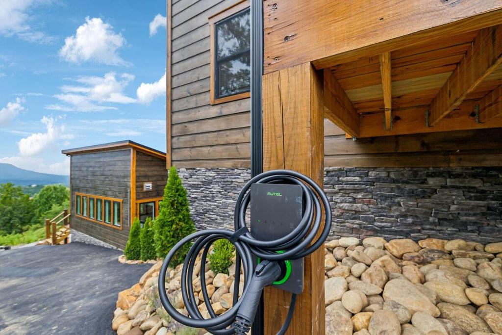 a rear view mirror on the side of a house at Honeybear Hideaways - #1 Luxury Haven Cabin with Breathtaking Mountain Views, Indoor Pool, Bowling Alley, and Golf in Pigeon Forge